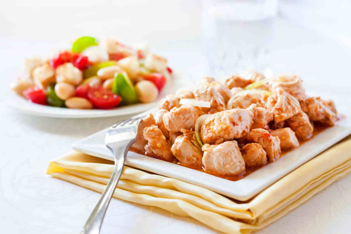 vassoio con bocconcini di tacchino con cipolle e rosmarino su tavolo bianco