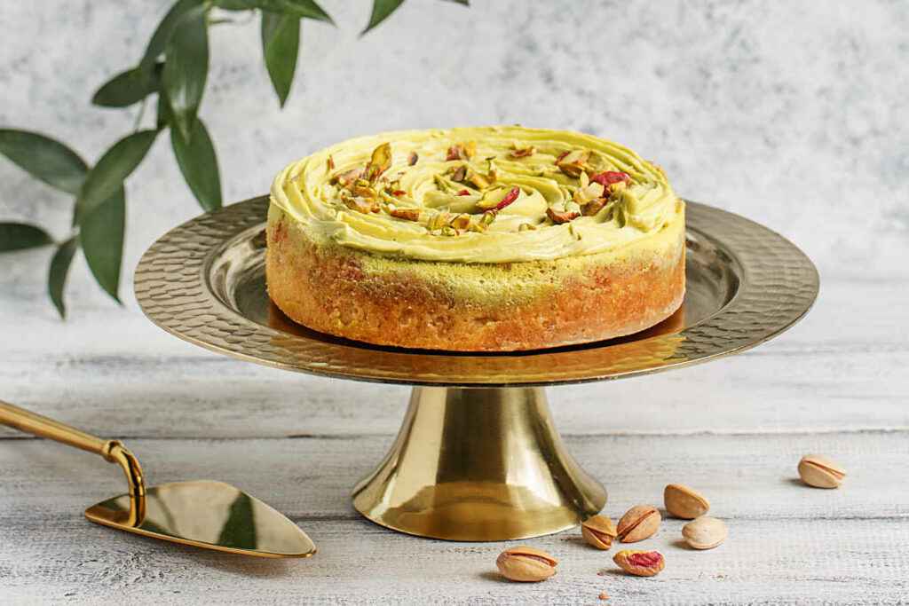 alzatina dorata con torta al pistacchio