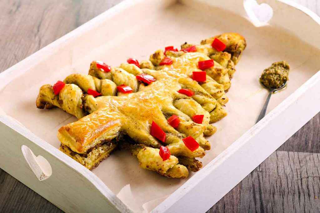 Albero di natale di pasta sfoglia salato con pomodorini e pesto