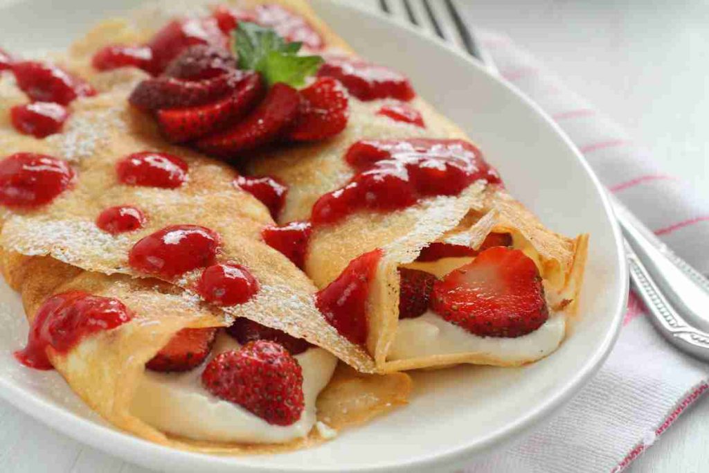 piatto con due Crepes con crema e fragole 