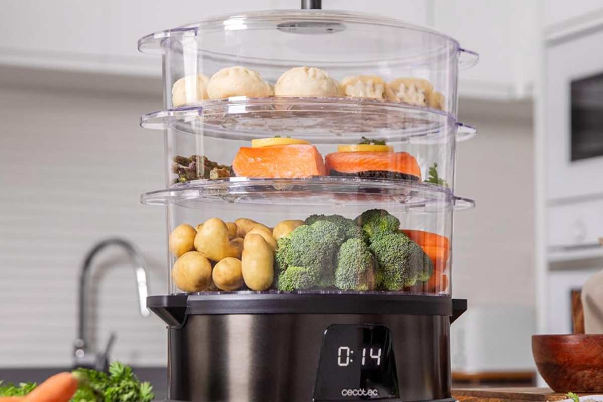 Una vaporiera su un piano di una cucina con dentro tante verdure e altro