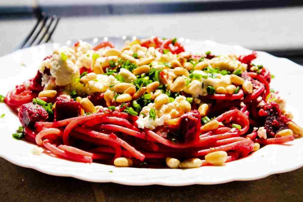 Spaghetti con crema di barbabietole pinoli feta