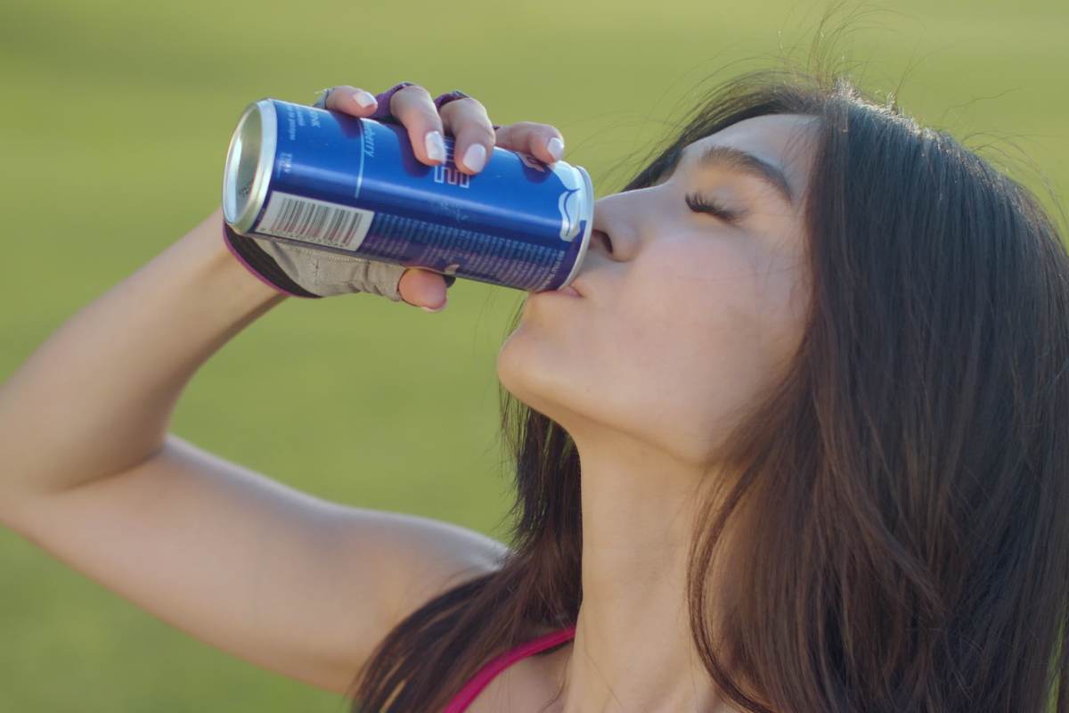 Ragazza beve una bibita energetica