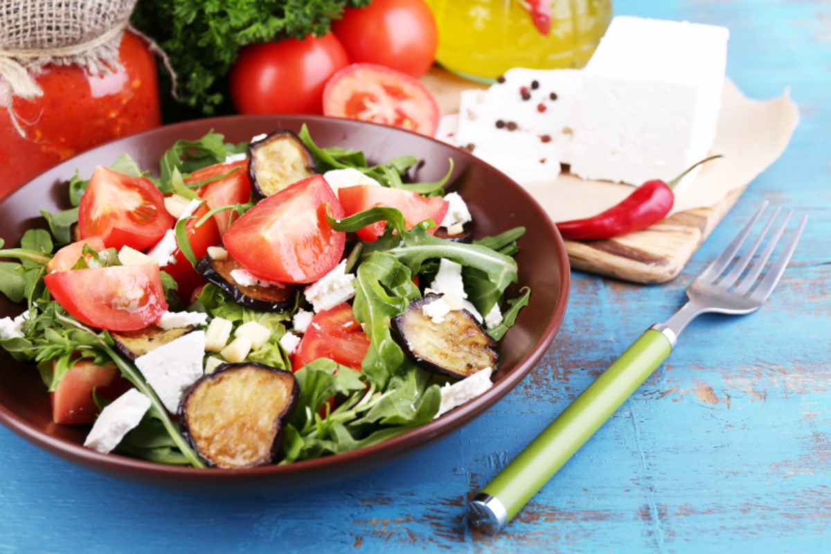 Insalata con rucola, melanzane, pomodori e feta