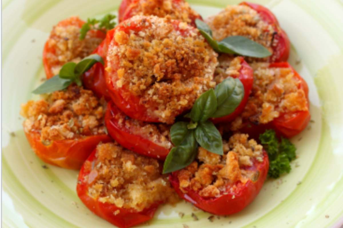 Pomodorini con pangrattato e basilico in un piatto