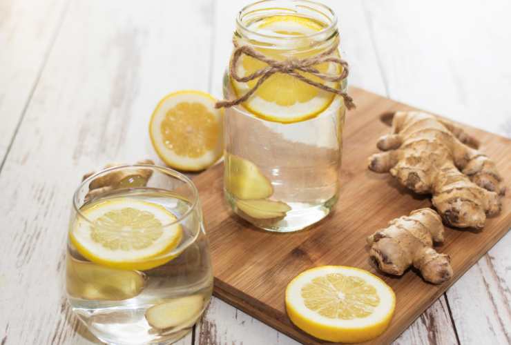 bicchiere e brocca con acqua limone e zenzero