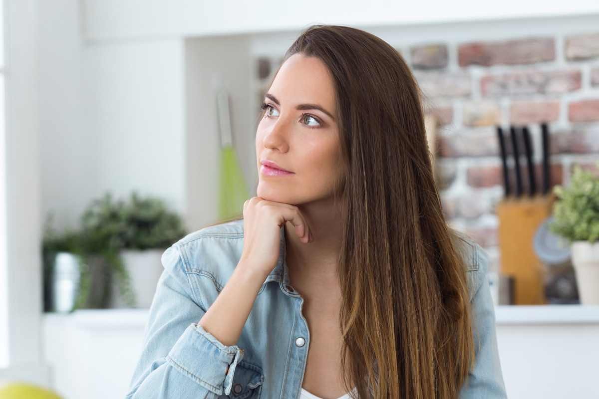 ragazza che pensa in cucina