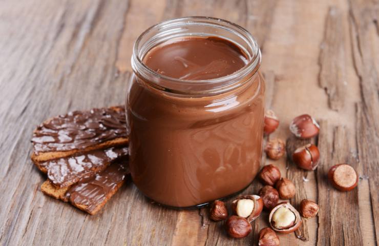 Un barattolo con crema di nocciole e cacao