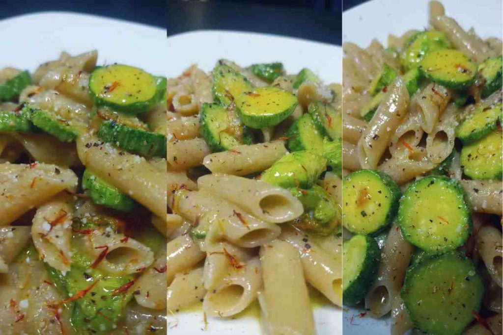 Penne di avena con zucchine romanesche, crema all'uovo e pistilli di zafferano in un piatto