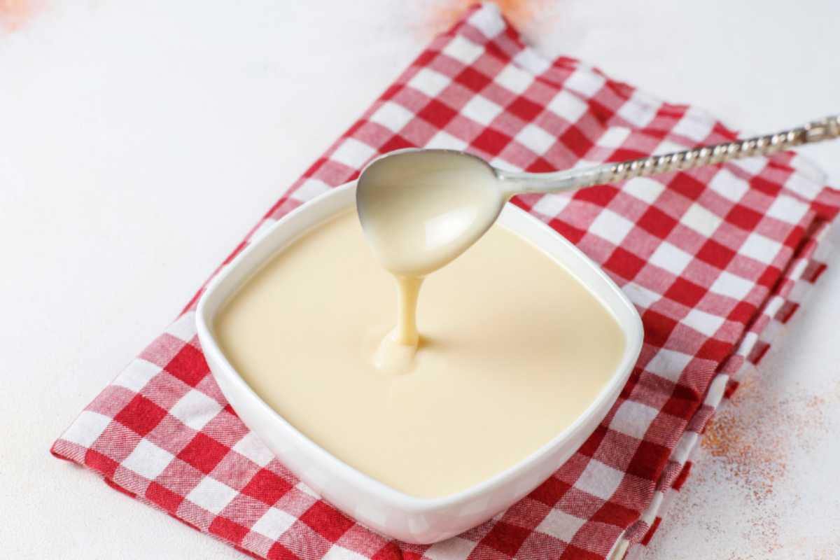 crema al latte in ciotola bianca con cucchiaino