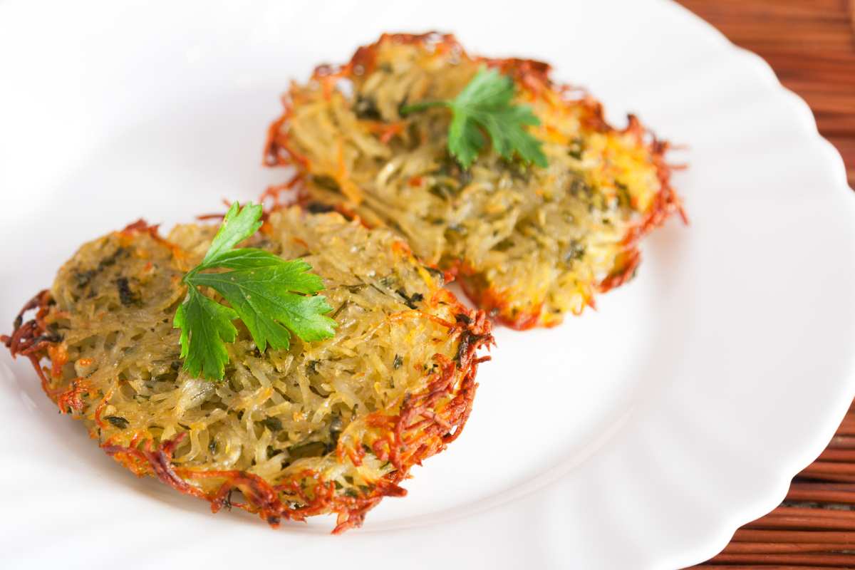 piatto di rosti con pollo, patate e zucchine