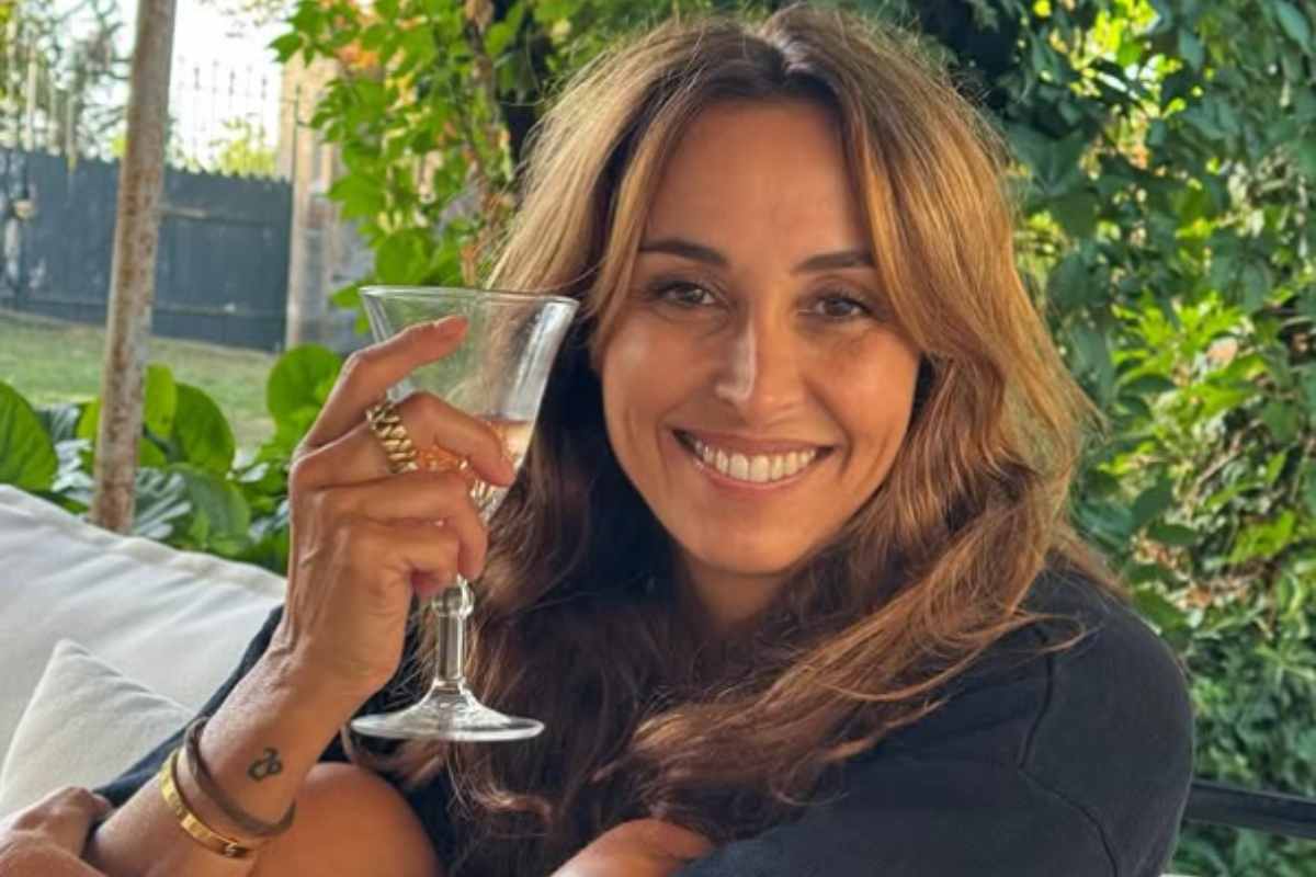 benedetta parodi che sorride con un calice di vino in mano