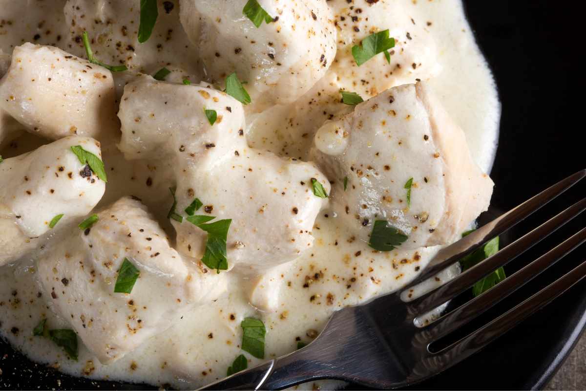bocconcini di pollo cremosi con forchetta