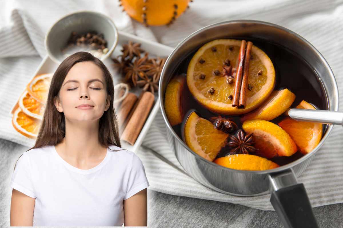 pentola con arancia cannella e chiodi di garofano e donna che annusa l'aria