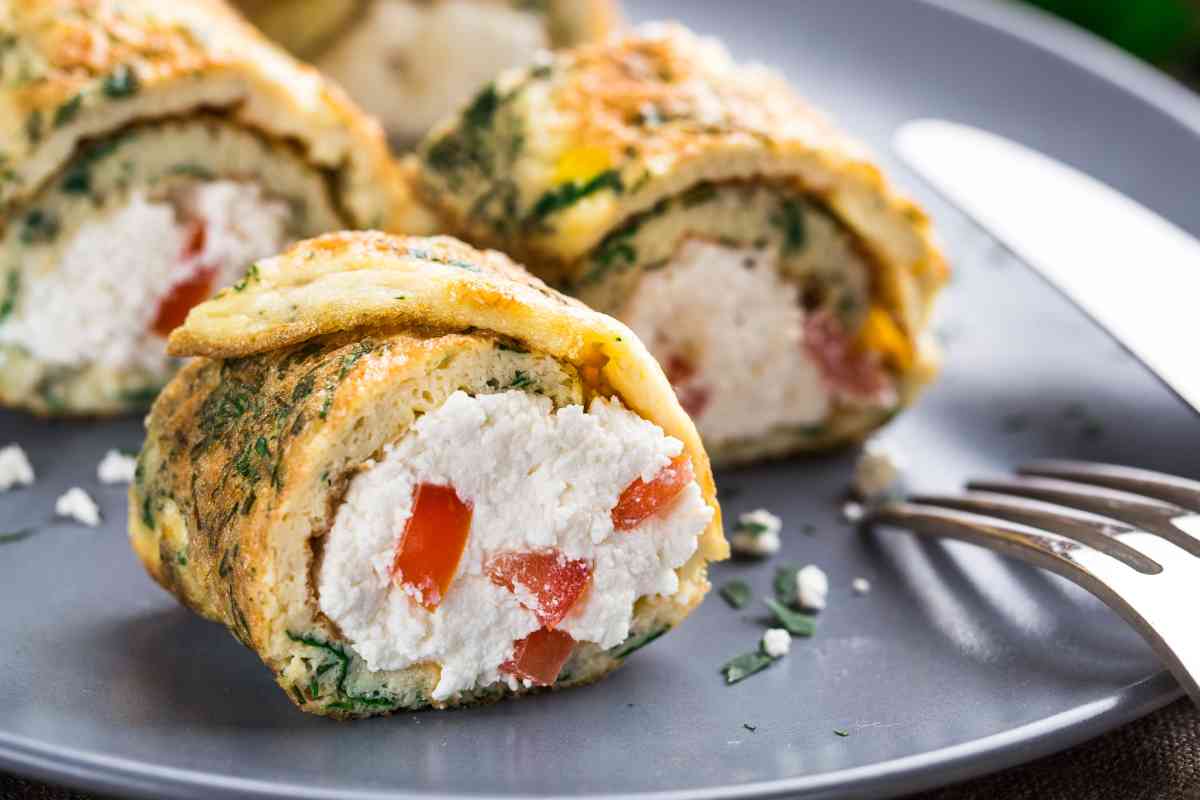 un piatto con dentro dei rotolini di frittata farcita con ricotta e pomodorini