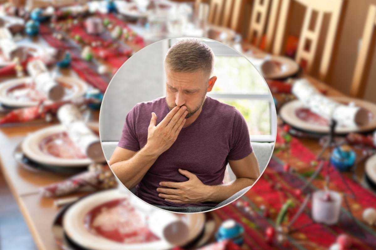 tavolata natalizia sullo sfondo e uomo con problemi digestivi nel riquadro al centro