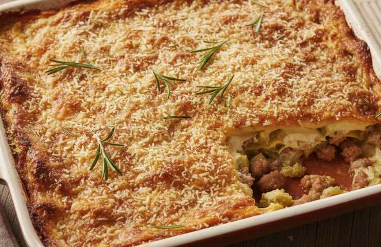 Una ricetta lasagna bianca carciofi e salsiccia tagliata e vista dall'alto